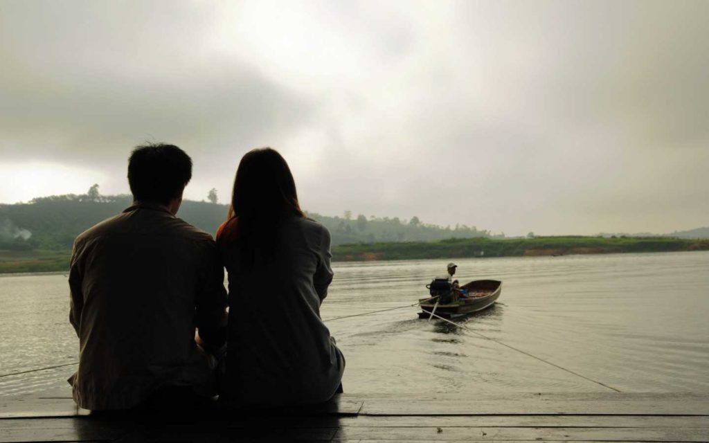 Couple Sitting nearby river